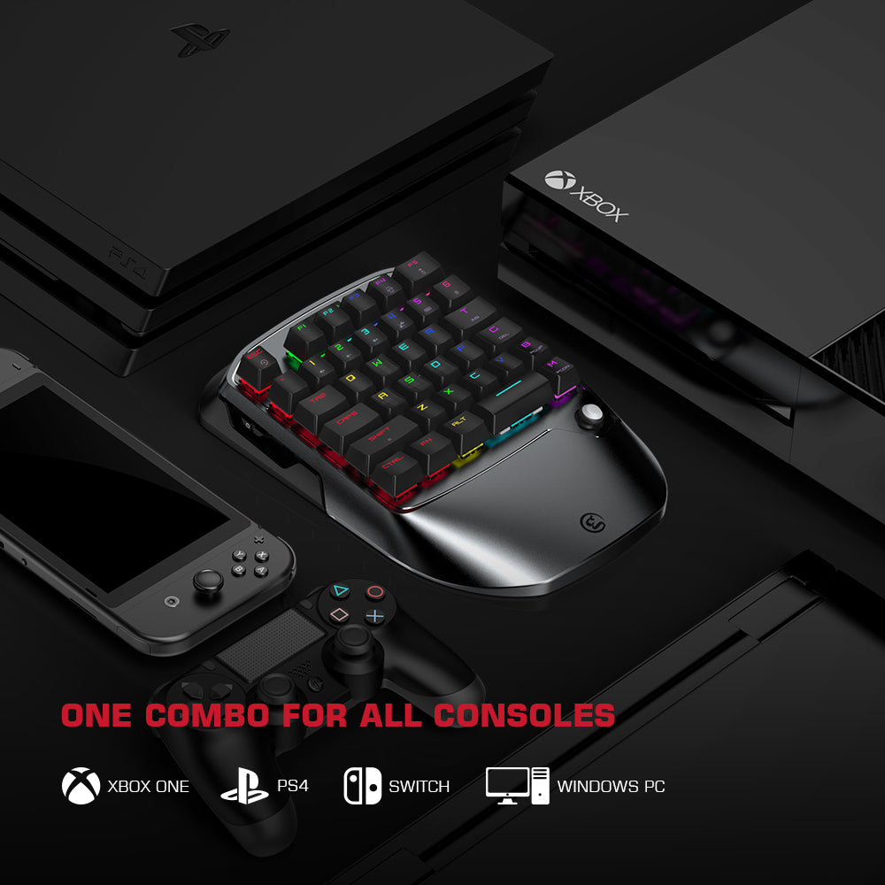 Gaming accessories including a keyboard and controllers on a black surface with console logos.