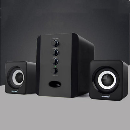 Black computer speakers with control panel on a gray background