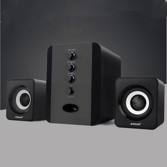 Black computer speakers with control panel on a gray background