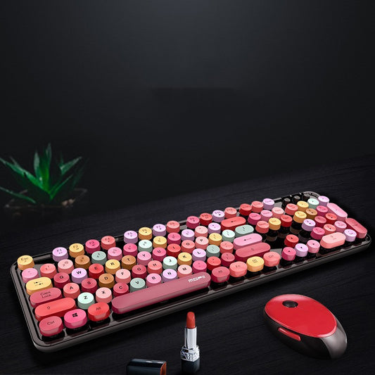 Colorful keyboard with a red mouse on a dark surface