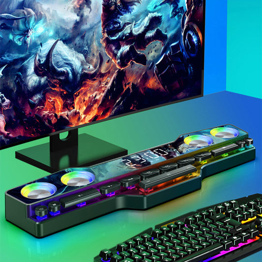 Gaming setup with a monitor displaying a colorful scene and a keyboard with RGB lighting on a green surface.
