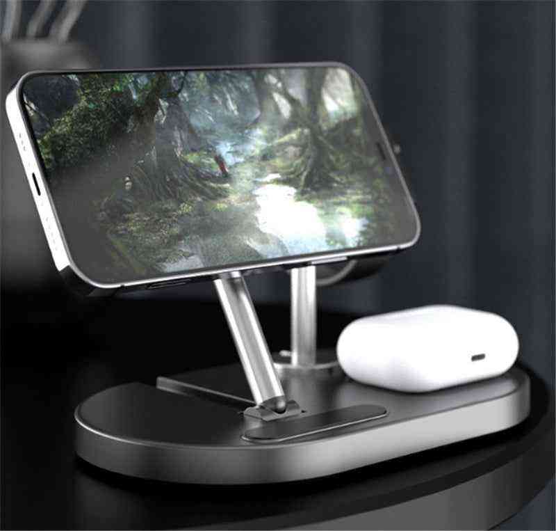 Phone stand with smartphone displaying a nature scene and wireless earbuds on a dark surface.