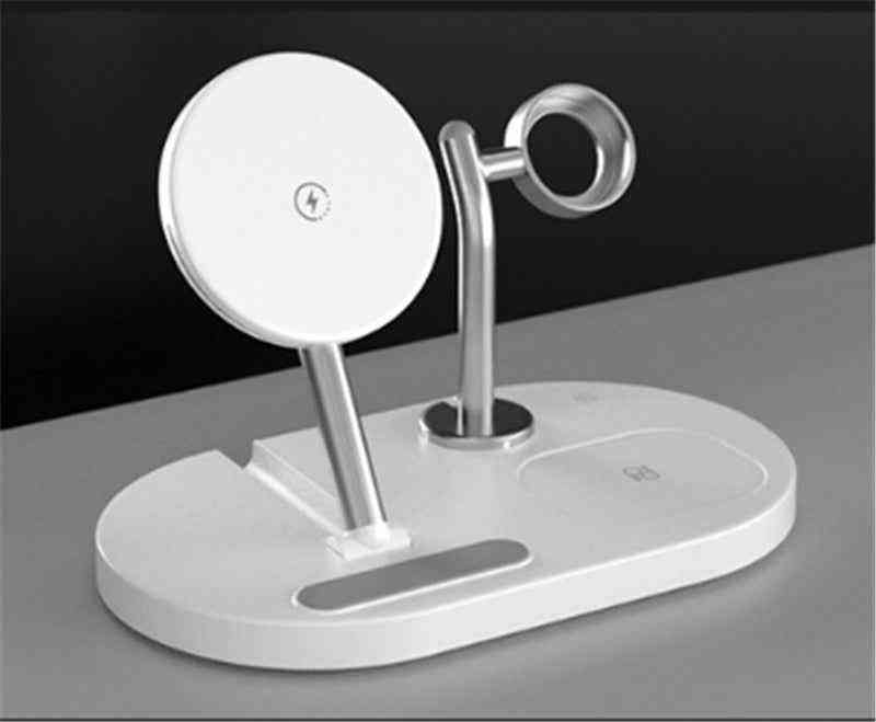 White phone stand with wireless charging pad on a gray surface
