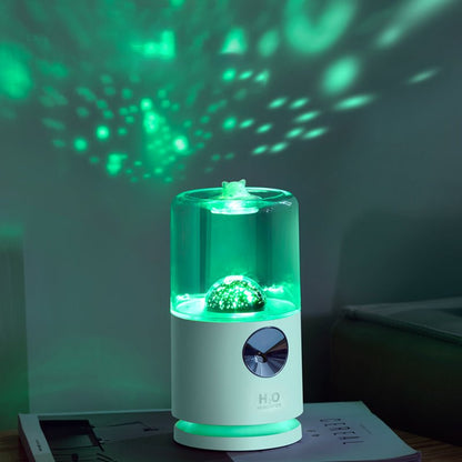 Laser projector with green light patterns on a dark background