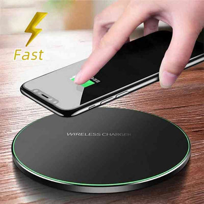 Hand placing a smartphone on a fast wireless charger for iPhone and Samsung.