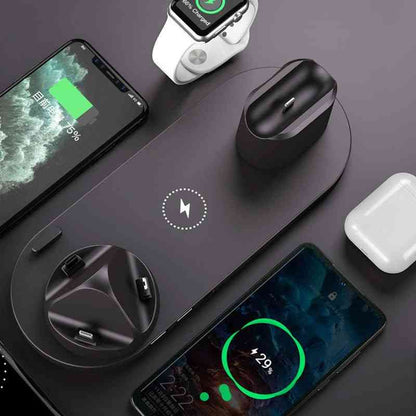 Wireless charging pad with smartphone, smartwatch, and earbuds on a dark surface