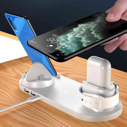Multi-device charging station with smartphone, tablet, and wireless earbuds on a wooden surface.