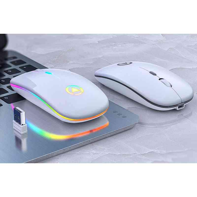 Two wireless computer mice on a keyboard with a USB cable emitting colorful lights.