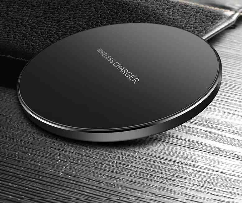 Black wireless charger on a wooden surface