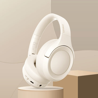 White headphones on a beige stand with a neutral background
