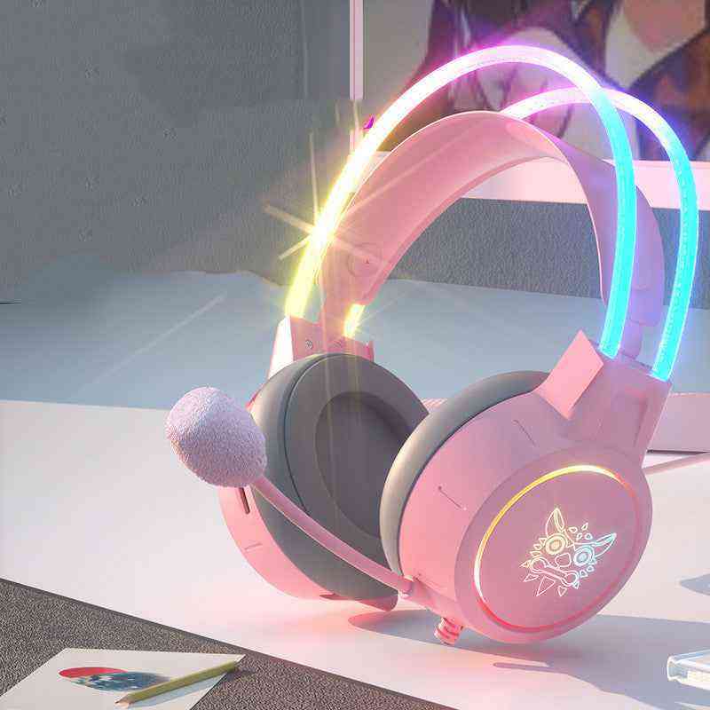 Pink gaming headset with colorful lights on a white surface