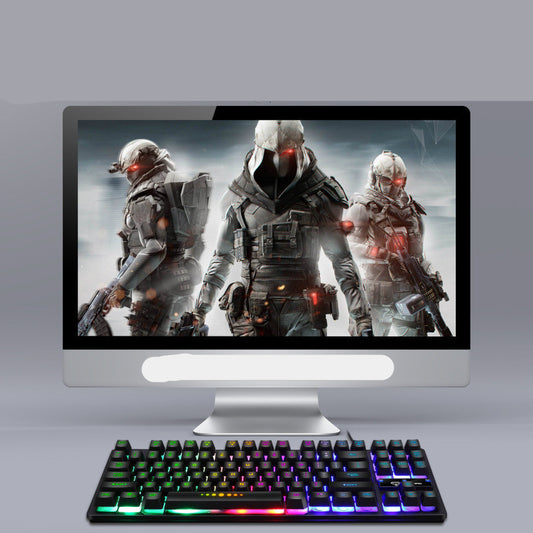 Computer monitor displaying a video game with a futuristic soldier theme, accompanied by a colorful keyboard.