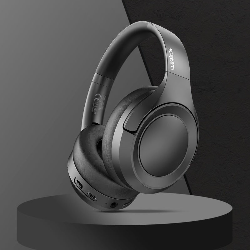Gray headphones on a black stand with a dark gray background
