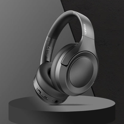 Gray headphones on a black stand with a dark gray background