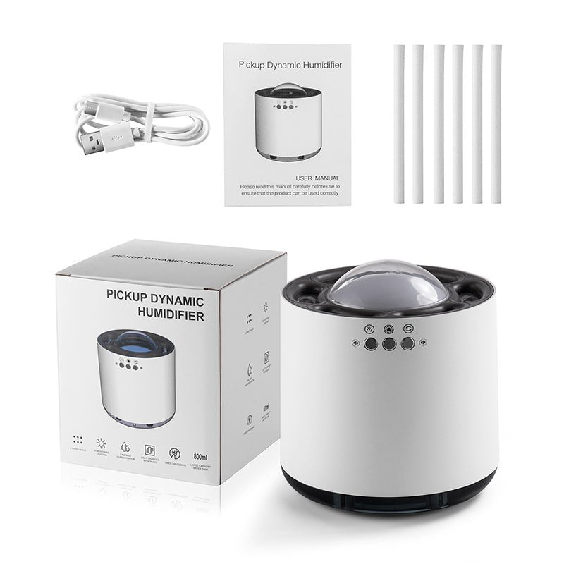White dynamic humidifier with packaging, USB cable, and replacement filters on a white background