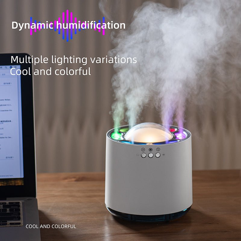Humidifier emitting steam with colorful lights on a wooden surface, laptop in the background.