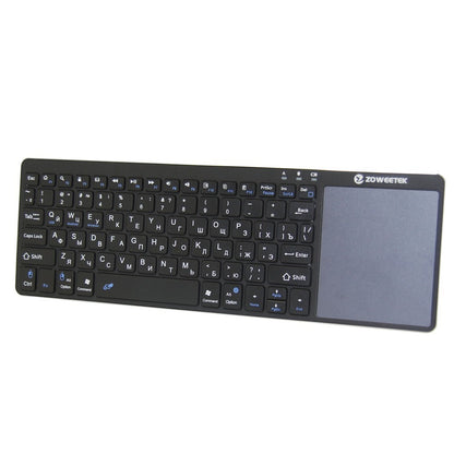 Black keyboard with touchpad on a white background