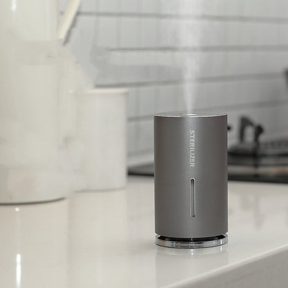 Gray sterilizer on a bathroom counter with blurred background