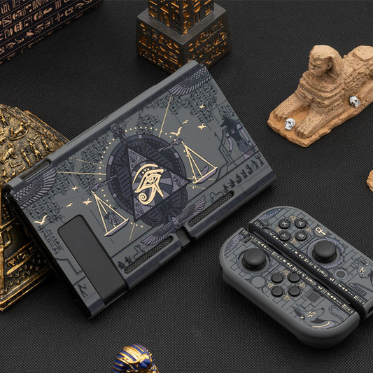 Gaming console with Egyptian-themed design and controller on a dark surface