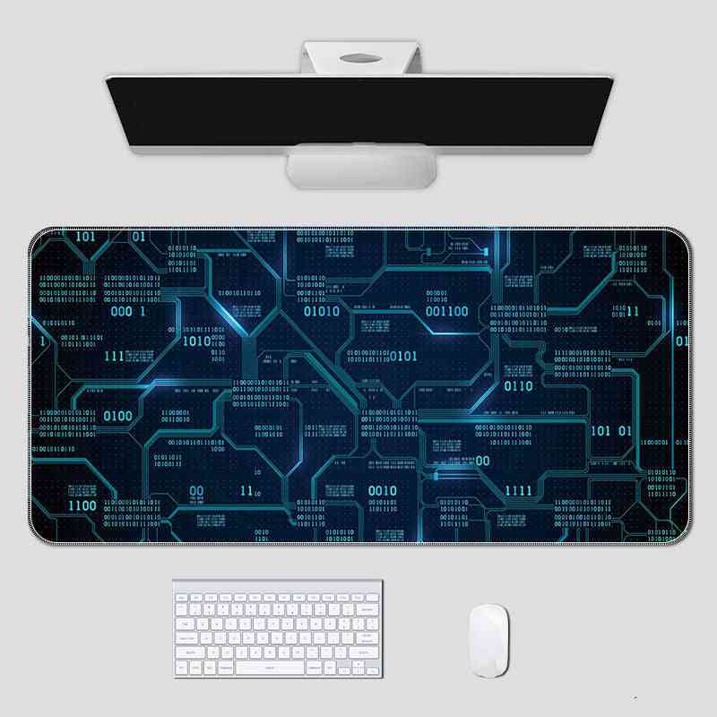 Computer setup with a large mouse pad featuring a blue circuit board design on a white surface.