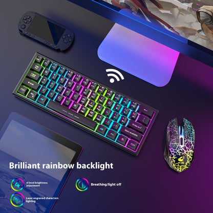Gaming keyboard with colorful backlighting on a desk with a mouse and handheld console.