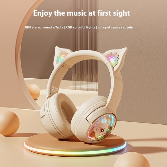 White headphones with cat ears on a stand, featuring RGB lights, on a beige background.