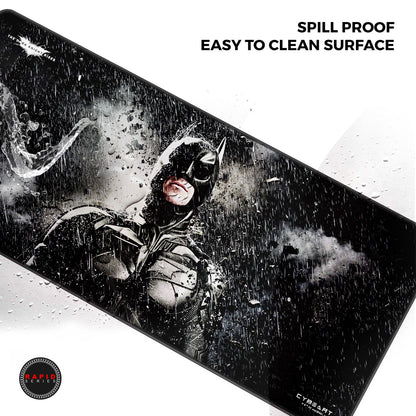 Large mouse pad with a superhero design and text about spill proof and easy cleaning surface, brand 'Cyrust' visible.