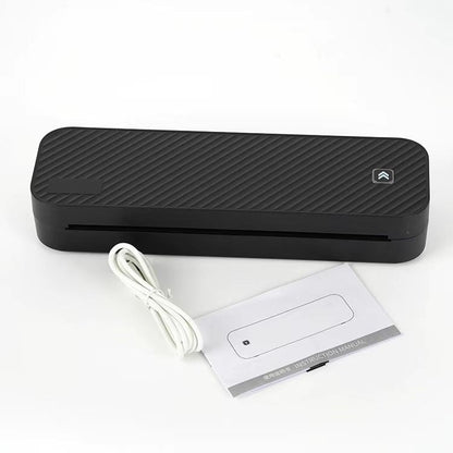 Black rectangular device with a cable and manual on a white background