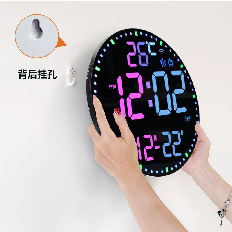 Digital clock with colorful display held by a hand on a white background