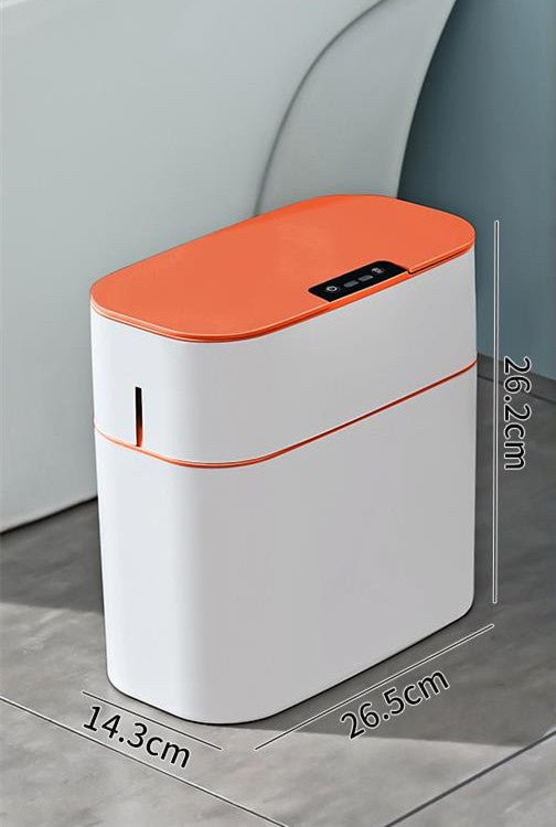 White and orange electronic device with dimensions displayed on a gray surface