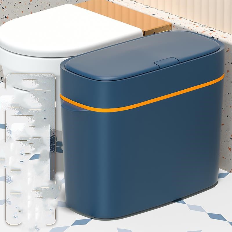 Blue trash can with an orange stripe on a bathroom floor.