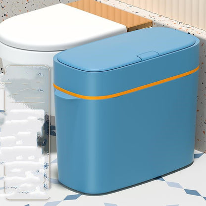 Blue trash can with an orange stripe on a bathroom floor.