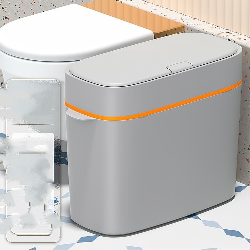 Gray trash can with an orange accent on a patterned surface
