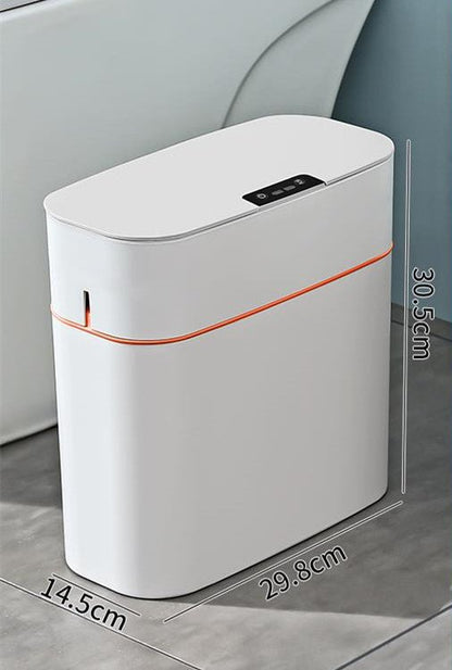 White electronic device with orange accent on a gray surface, showing dimensions.
