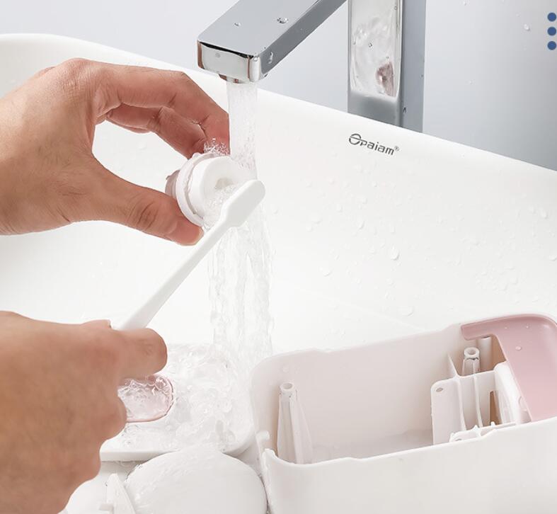 Person washing a toothbrush under running water with a faucet labeled 'Opalaim' in the background.