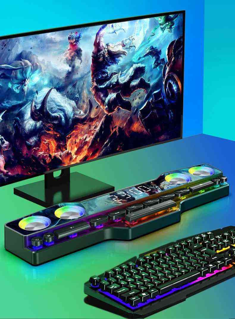 Gaming setup with monitor, keyboard, and RGB lighting on a green and blue gradient background