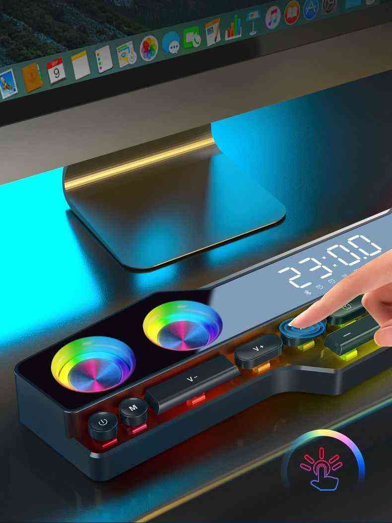 Gaming desk setup with RGB lighting and digital clock