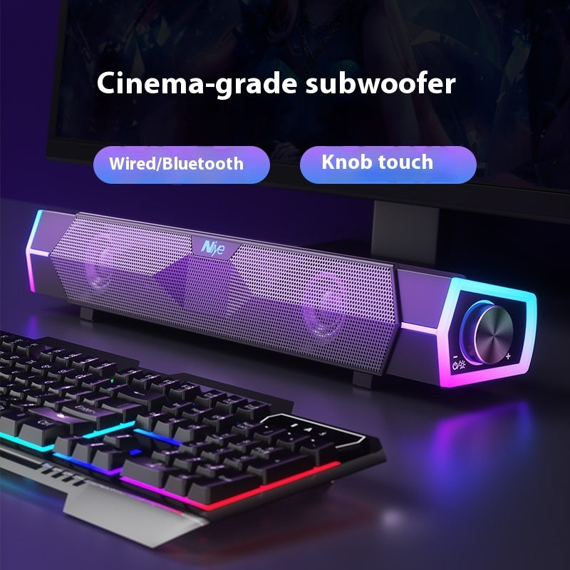 Cinema-grade subwoofer with RGB lighting next to a keyboard on a dark background