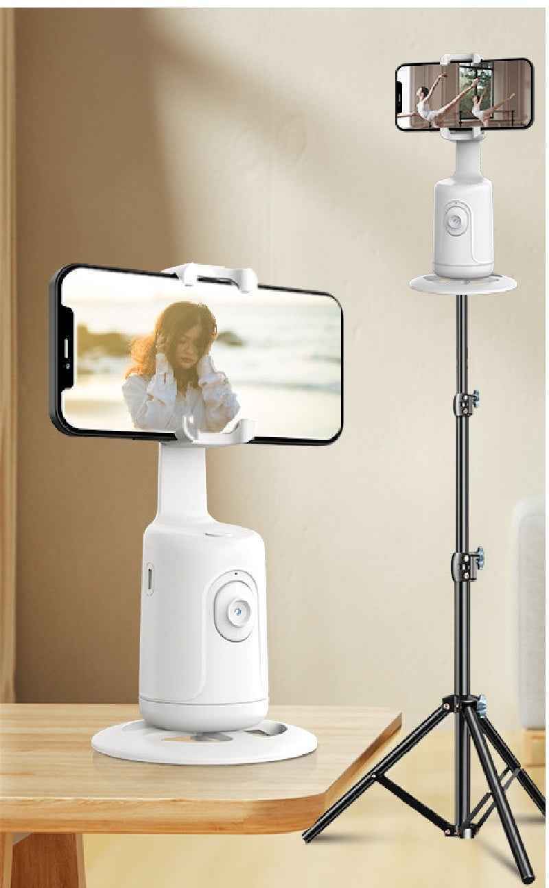 Phone holder with a smartphone on a stand, displaying a person on the screen.