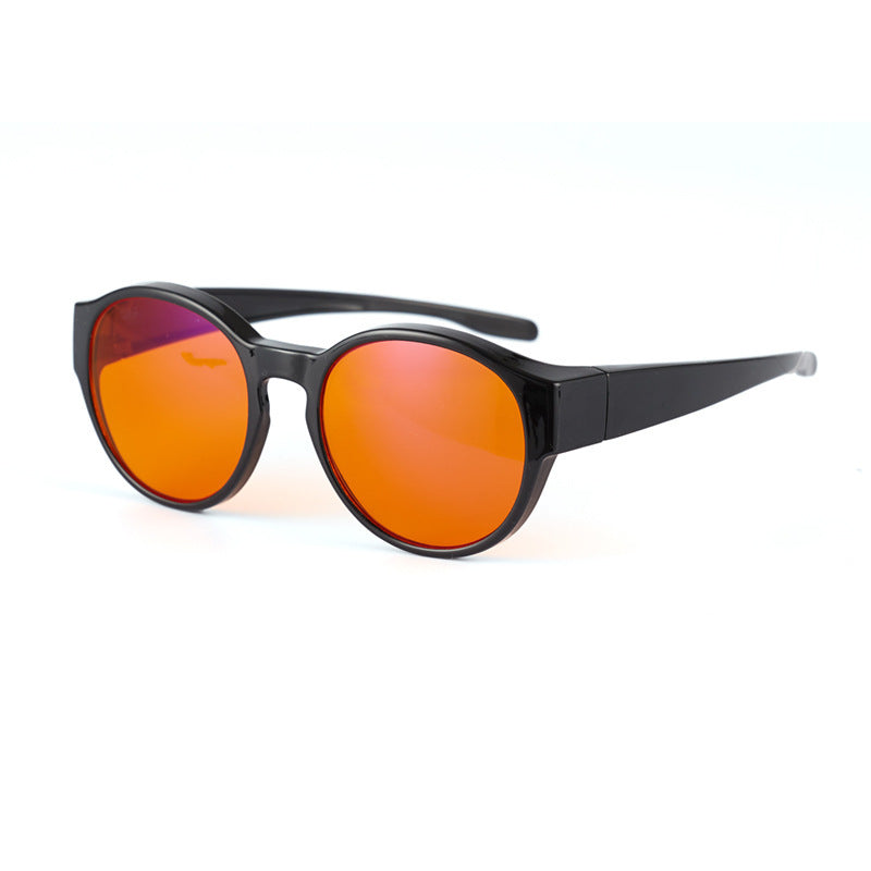 Black-framed sunglasses with orange lenses on a white background