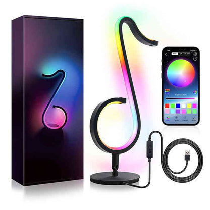 Colorful LED lamp shaped like a music note with smartphone app control, packaging, and USB cable.