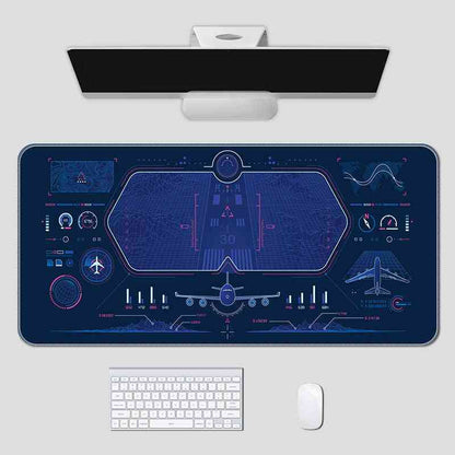 Futuristic desk setup with a large mouse pad featuring aviation-themed design, keyboard, and mouse on a white background.