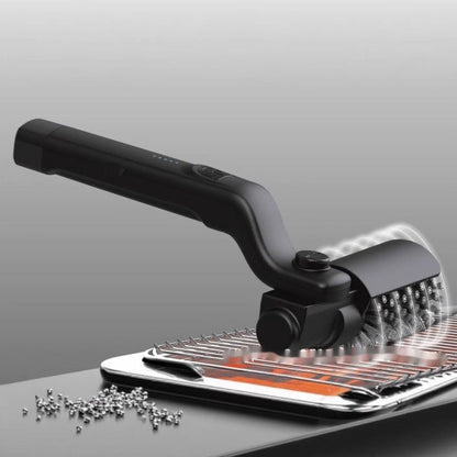 Black handheld tool with a metallic surface on a gray background