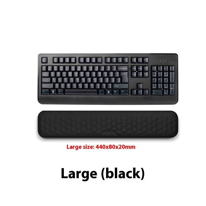 Black keyboard and wrist rest on a white background