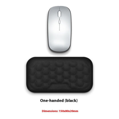 Silver computer mouse and black mouse pad on a white background