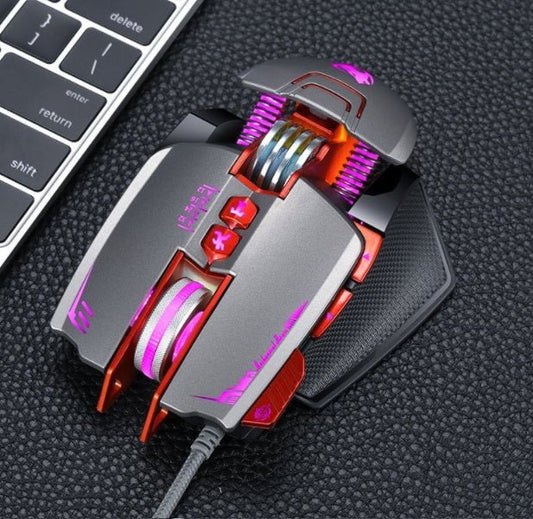 Gaming mouse with RGB lighting on a textured surface next to a keyboard