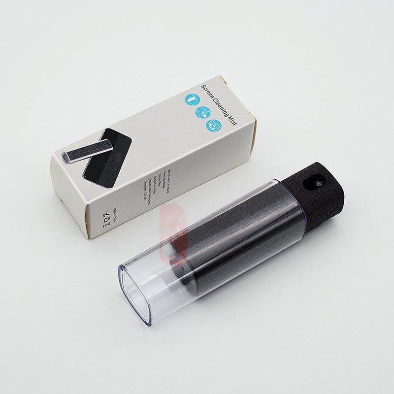 Clear spray bottle with black cap and white box on a light gray background