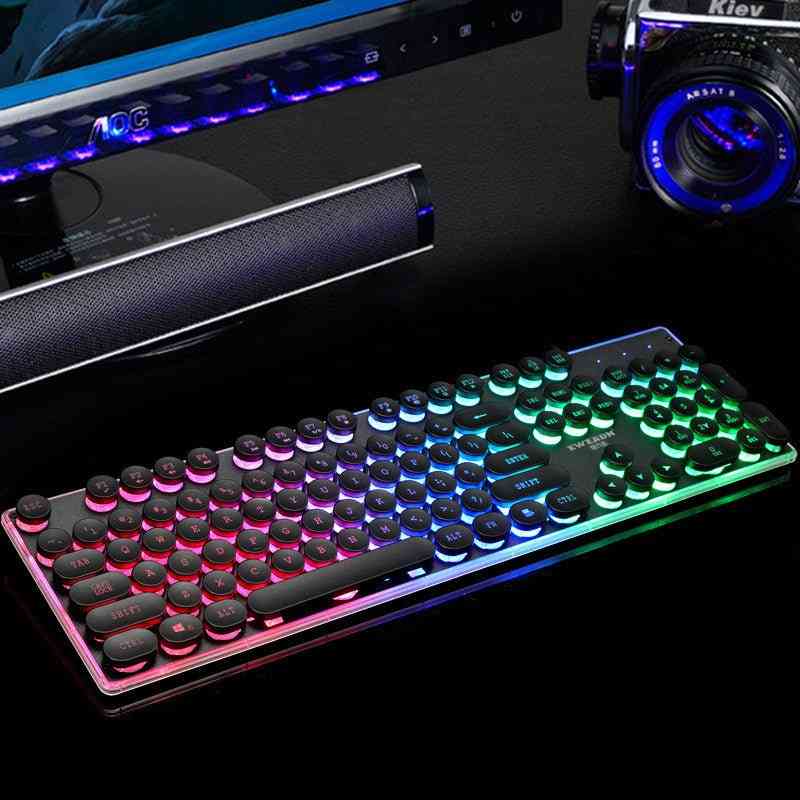 Gaming keyboard with RGB lighting on a desk with computer equipment.