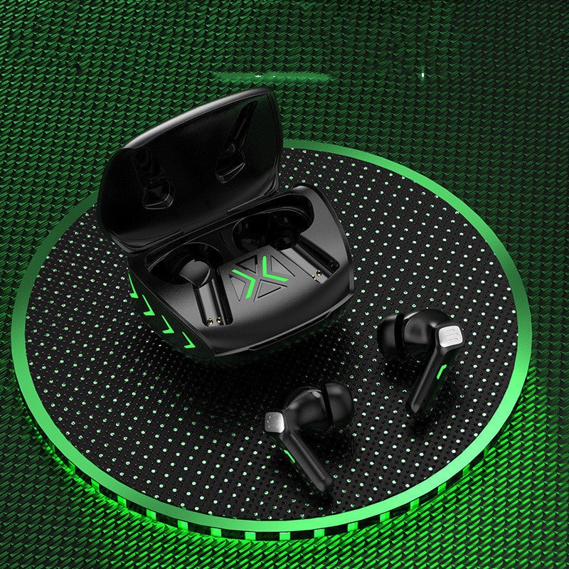 Black wireless earbuds with charging case on a green textured background