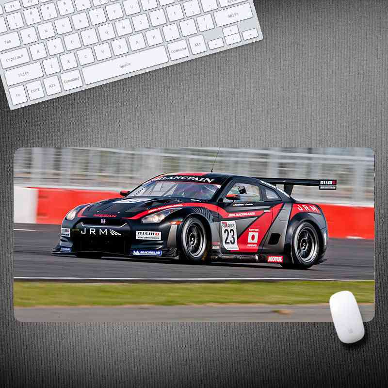 Racing car design mouse pad on a desk with keyboard and mouse.